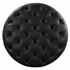 Moroccan Leather Pouf black leather ottoman in a living room setting with a beige sofa and plant.